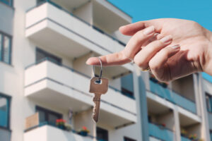 man holding a key to his apartment